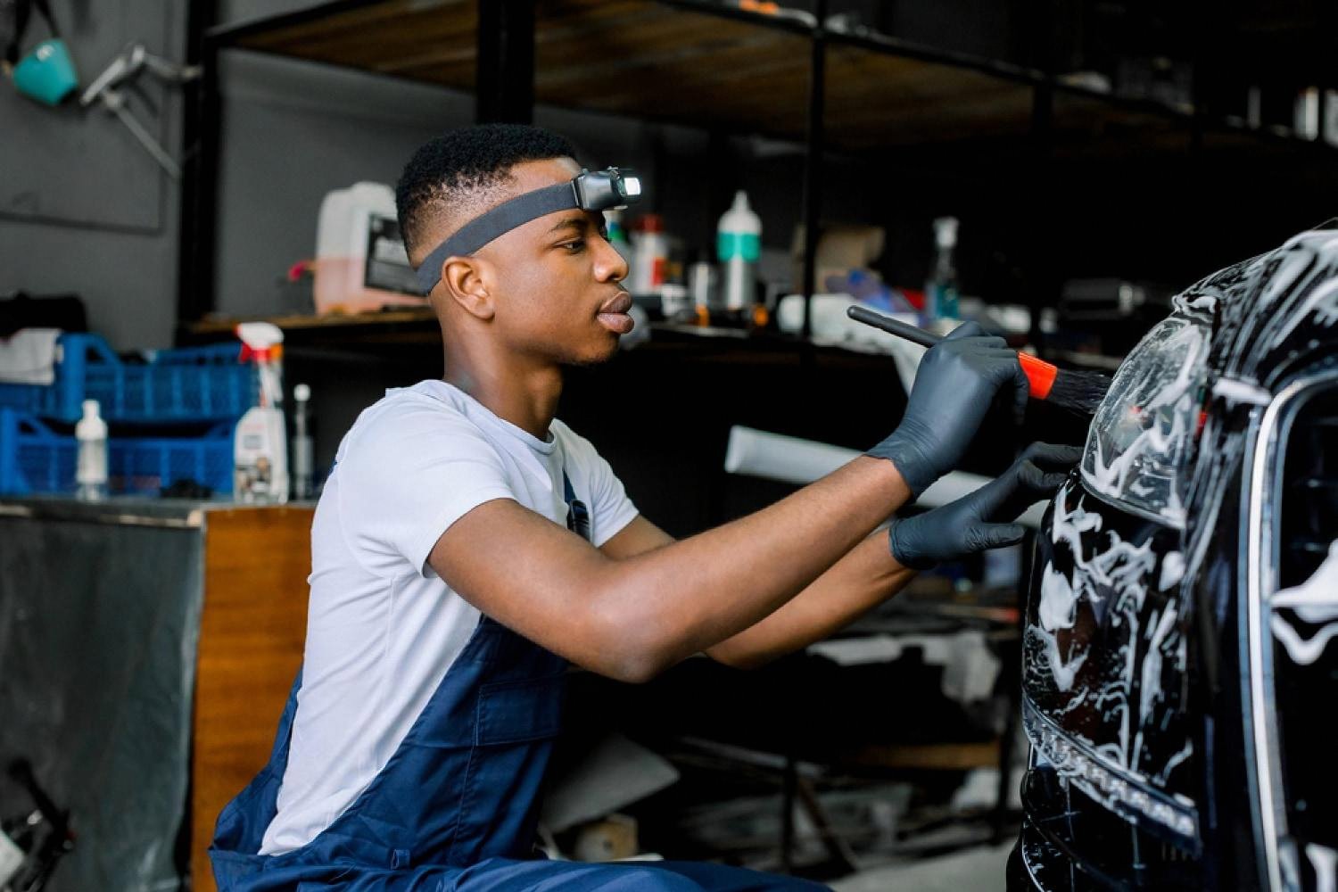 Auto detailing technician working on a vehicle in a UAE detailing studio