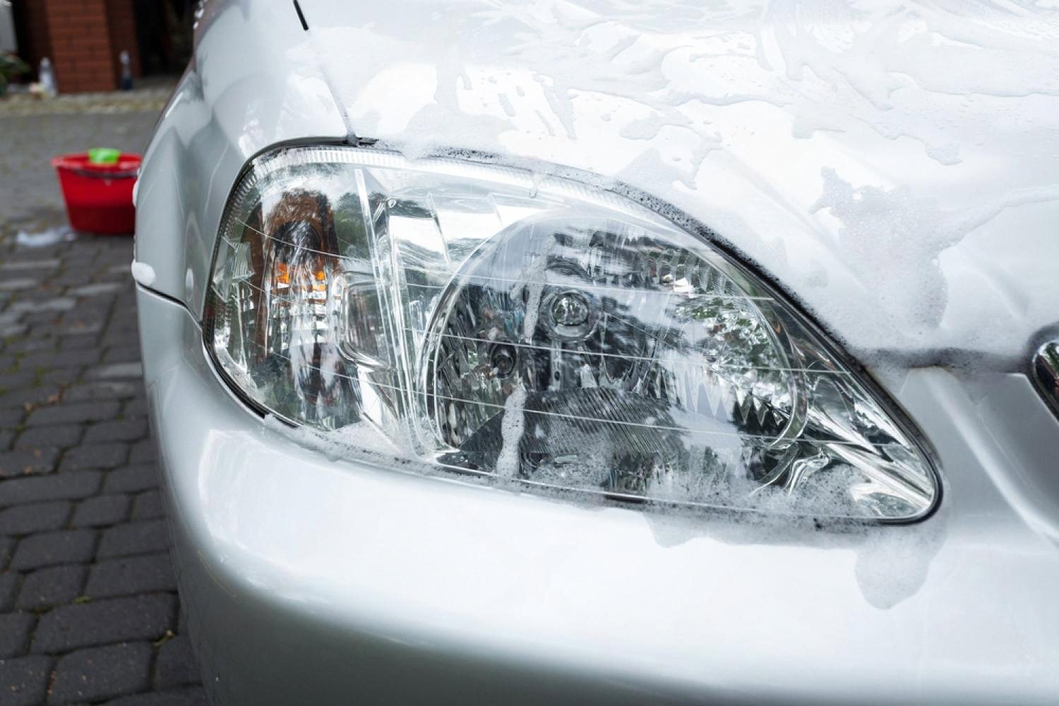 Car headlight covered in foam during exterior wash in the UAE